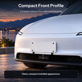White Model Y beside a lake at dusk, showing the front license plate panel and bracket placement.