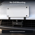 Close-up of the front license plate panel and grille mounting area, with the central camera visible below.