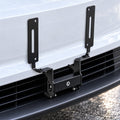 License plate bracket mounted to the front grille without a plate, showing two upright slotted arms.
