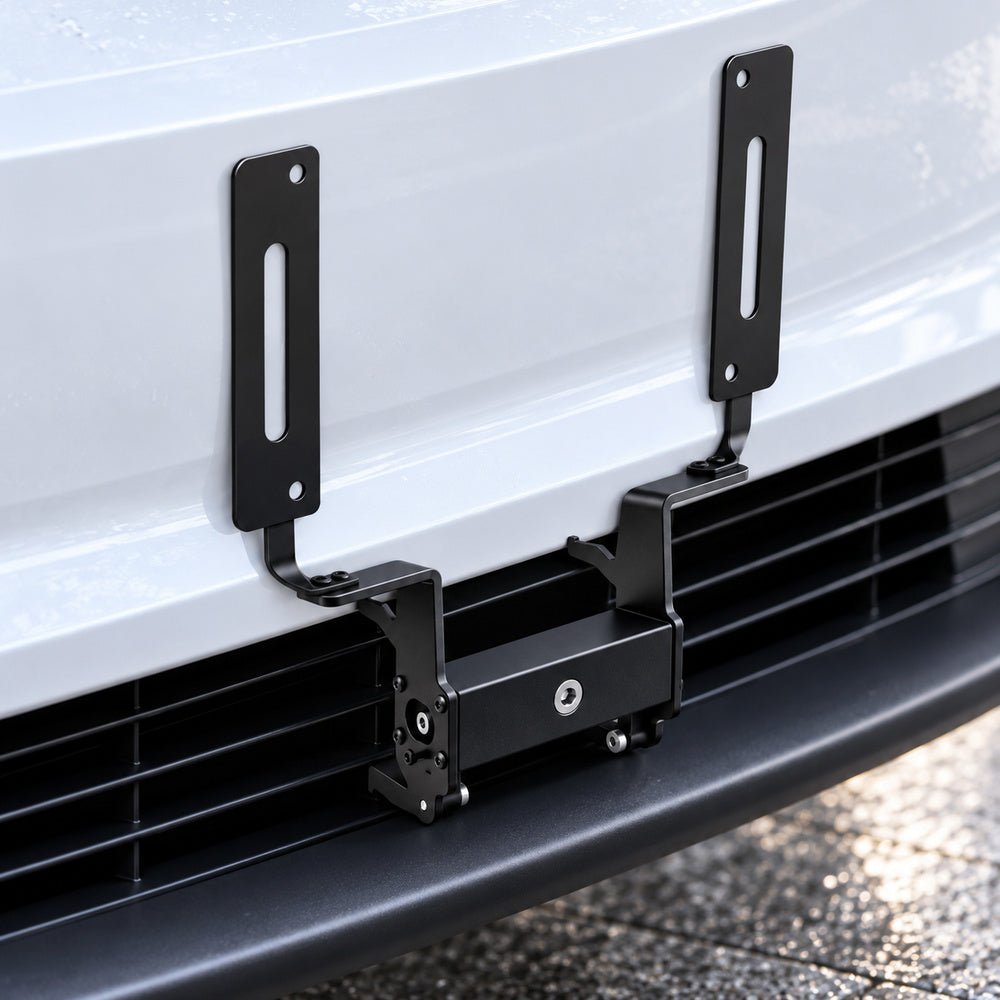 License plate bracket mounted to the front grille without a plate, showing two upright slotted arms.