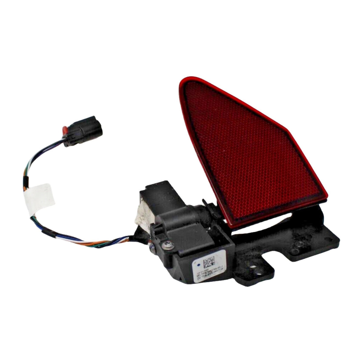 Model S charge port door assembly with red reflector, black actuator and attached wiring on white background